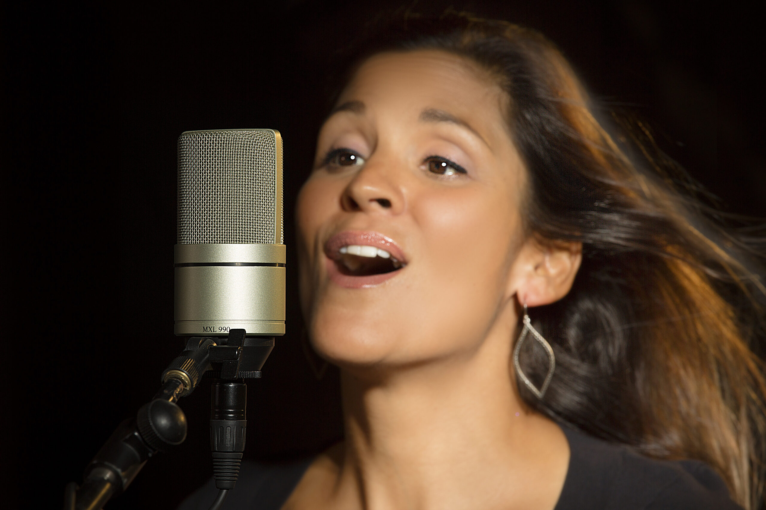 A girl singing in MXL 990 Large-diaphragm Condenser Microphone