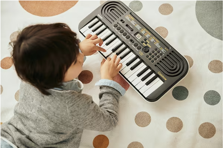 A kid playing Casio Kids Keyboard - SA51